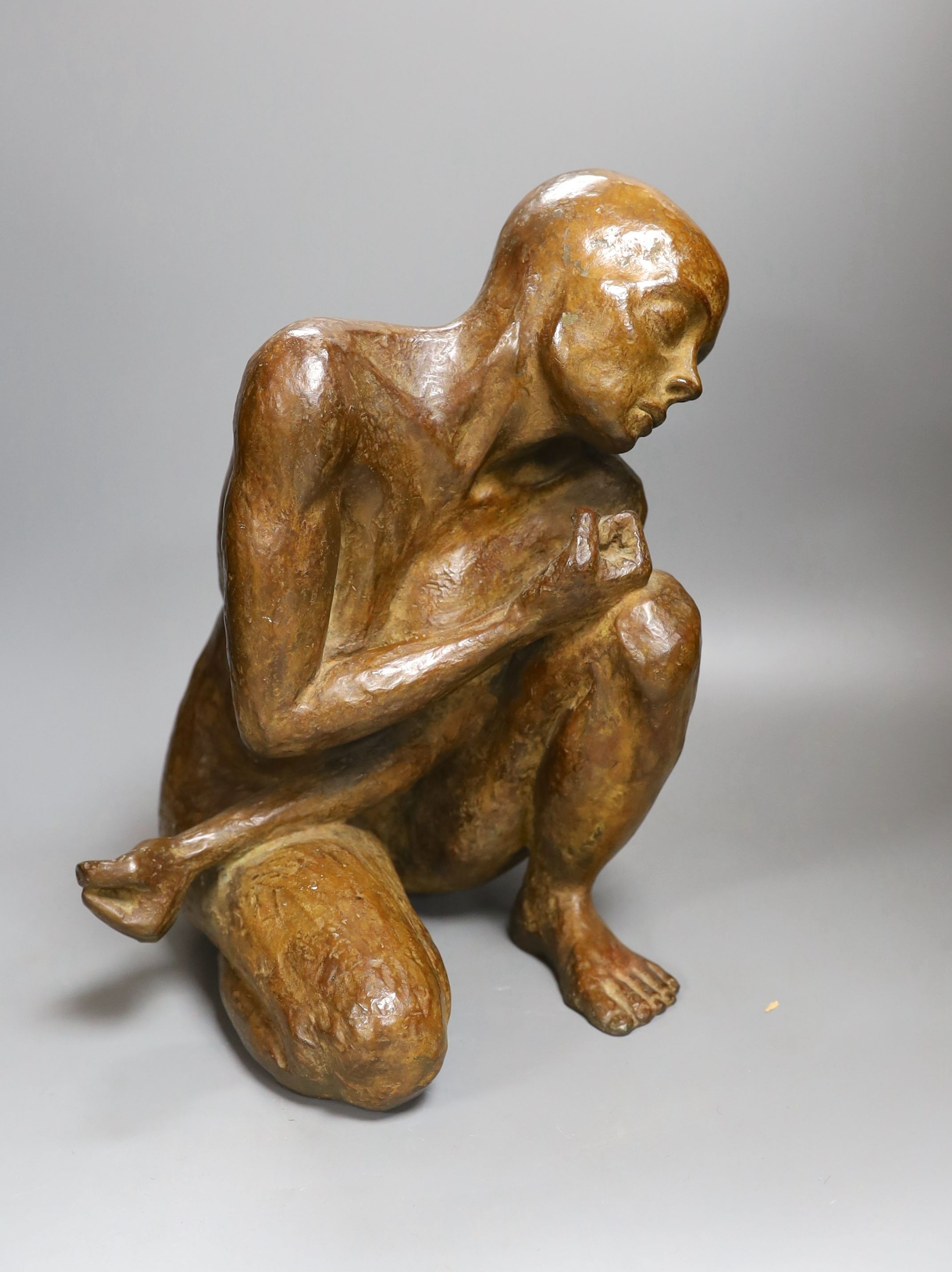 A contemporary bronze of a lady crouching with a thoughtful expression, unsigned - 31cm high